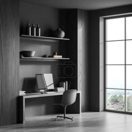 Foto de Esquina de la elegante oficina en casa con paredes de madera gris y oscura, suelo de hormigón, cómoda mesa de ordenador con silla gris y ventana con vista a la montaña. renderizado 3d - Imagen libre de derechos