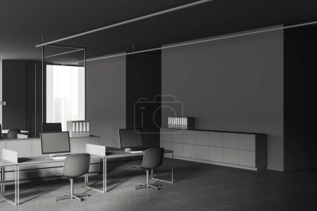 Foto de Interior de la elegante oficina de espacio abierto con paredes grises, suelo de baldosas, mesas de ordenador grises con sillas y gabinete de archivos grises. renderizado 3d - Imagen libre de derechos