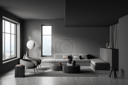Foto de Espacio de relax oscuro interior con sofá y dos sillones, mesa de centro y soporte con decoración, alfombra en piso de hormigón gris. Ventana panorámica en el campo. Renderizado 3D - Imagen libre de derechos