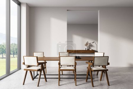 Photo for Front view on bright dining room interior with dining table, chairs, white wall, concrete floor, panoramic window with countryside view. Concept of minimalist design. 3d rendering - Royalty Free Image