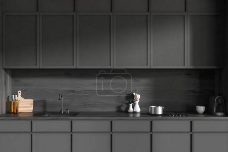 Photo for Dark kitchen interior with sink, stove and modern kitchenware. Cooking space in hotel apartment, 3D rendering - Royalty Free Image