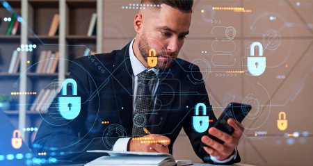Businessman working with phone and take note in notebook, double exposure with dashboard and padlock icons hologram. Concept of cybersecurity, encryption and data privacy