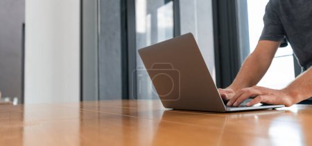 Photo for Businessman hands typing on laptop, texting in computer on wooden table at home living room. Concept of internet online shopping, website and communication - Royalty Free Image