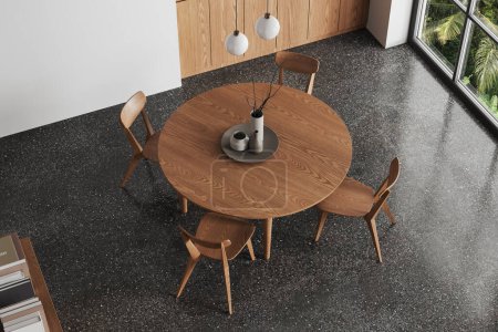 Foto de Vista superior del interior de la cocina de casa moderna con mesa y sillas de madera, suelo de hormigón gris. Comer esquina cerca de ventana panorámica en los trópicos. Renderizado 3D - Imagen libre de derechos