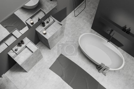 Top view of bathroom interior with bathtub and double sink with accessories, foot towel on grey concrete floor. Washing area in modern hotel. 3D rendering