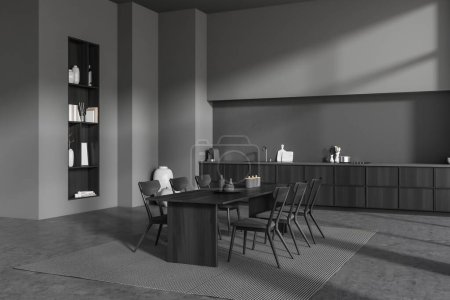 Foto de Vista de esquina en el interior de la habitación de la cocina oscura con mesa de comedor, sillas, armario, pared gris, piso de hormigón, estantes, libros, alfombra, máquina de café. Concepto de diseño minimalista. renderizado 3d - Imagen libre de derechos