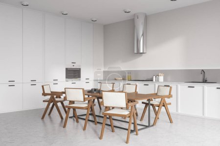 Téléchargez les photos : Intérieur de la cuisine blanche avec chaises et table à manger au sol en béton clair, vue latérale. Ustensiles de cuisine et coin repas, appareils modernes. rendu 3D - en image libre de droit