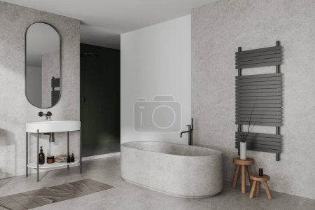 Téléchargez les photos : Confortable intérieur de la maison salle de bain avec baignoire et douche dans le coin, vue latérale au sol en béton. Évier avec miroir ovale et accessoires minimalistes, maquette murale vide. rendu 3D - en image libre de droit