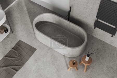 Photo for Top view of modern bathroom interior with bathtub on grey concrete floor. Hotel bathing corner with wooden stool and towel rail ladder. 3D rendering - Royalty Free Image