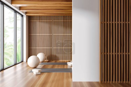 Foto de Interior de un elegante estudio de yoga con paredes blancas y de madera, suelo de madera, colchonetas de yoga y pelotas blancas. Pared en blanco a la derecha. renderizado 3d - Imagen libre de derechos