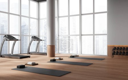 Téléchargez les photos : Coin de la salle de gym moderne avec murs blancs, plancher en bois, tapis de course et tapis de yoga gris. Concept de sport et mode de vie actif. Rendu 3d - en image libre de droit