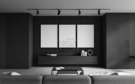 Photo for Dark home living room interior with sofa, minimalist sideboard with art decoration and books, grey concrete floor. Three mock up blank posters in row. 3D rendering - Royalty Free Image