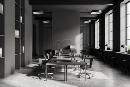Photo for Dark coworking room interior with chairs and pc computer in row, grey concrete floor. Business conference room and panoramic window on countryside. 3D rendering - Royalty Free Image