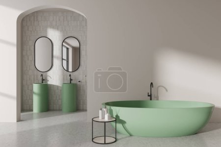 Téléchargez les photos : Intérieur de salle de bain moderne avec murs blancs, sol en béton, confortable baignoire verte et double lavabo avec des miroirs oblongs en arrière-plan. Rendu 3d - en image libre de droit