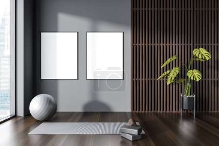 Photo for Dark wooden gym class interior with mat and fitball on hardwood floor, panoramic window on Kuala Lumpur. Sport room with two mock up canvas posters. 3D rendering - Royalty Free Image