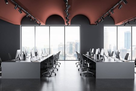 Foto de Moderno interior de coworking con sillones y ordenador PC en fila en el escritorio, piso de hormigón gris. Oficina de negocios y ventana panorámica en Kuala Lumpur. Renderizado 3D - Imagen libre de derechos