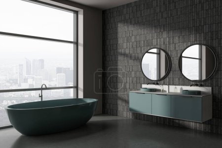 Photo for Corner of stylish bathroom with gray and tiled walls, concrete floor, comfortable dark green bathtub and double sink with two round mirrors. 3d rendering - Royalty Free Image