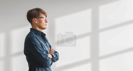 Photo for Portrait of confident young European businessman standing with crossed arms over white background. Concept of leadership. Copy space - Royalty Free Image