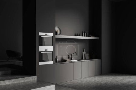 Photo for Corner view on dark kitchen room interior with cupboard, grey wall, concrete floor, oven, shelves, armchair, cooking inventory. Concept of minimalist design. 3d rendering - Royalty Free Image