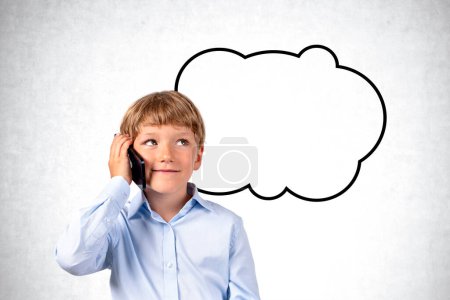 Photo for Dreaming boy talking on the phone, copy space empty speech thought bubble on grey concrete wall background. Concept of online communication, thought and idea - Royalty Free Image