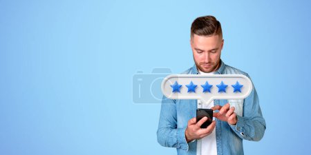 Photo for Businessman finger touch phone in hand, five stars bubble on empty copy space blue background. Concept of giving positive review online, client service and rank - Royalty Free Image