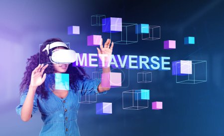 Black young woman working in vr glasses, hands touching hologram of information fields, colorful data blocks in metaverse. Concept of futuristic technology
