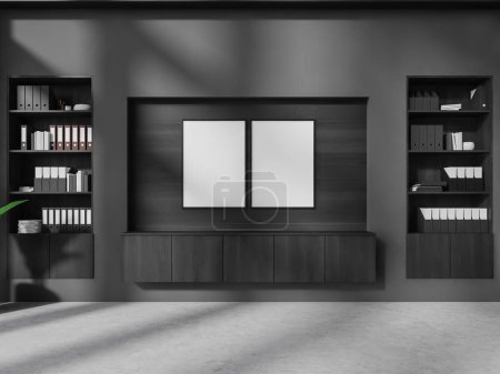 Foto de Interior de la oficina elegante con paredes grises y de madera, piso de hormigón, gabinete con dos carteles de la maqueta vertical encima de él y librerías. renderizado 3d - Imagen libre de derechos