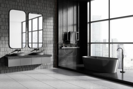 Téléchargez les photos : Coin de salle de bain élégante avec des murs de tuiles grises, sol en béton, baignoire grise confortable debout près de la fenêtre panoramique et double lavabo avec deux miroirs verticaux. Rendu 3d - en image libre de droit