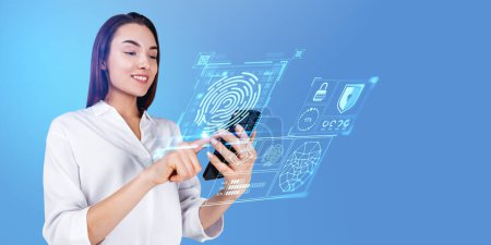 Photo for Portrait of cheerful young businesswoman in white shirt using smartphone with immersive fingerprint interface over light blue background. Concept of data protection in business and private life - Royalty Free Image