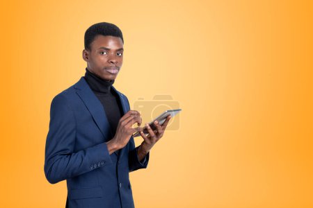 Photo for Black businessman with tablet in hands, smiling portrait looking at the camera. Concept of online connection and network. Copy space - Royalty Free Image