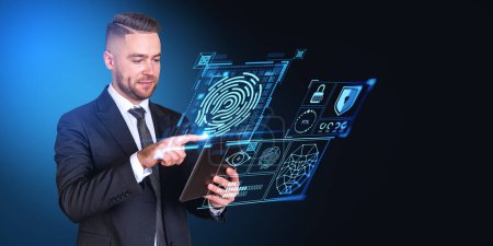 Photo for Bearded young European businessman in elegant suit using tablet computer with immersive fingerprint interface over dark blue background. Concept of data protection in business and private life - Royalty Free Image