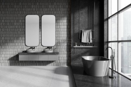 Photo for Interior of stylish bathroom with gray tile walls, concrete floor, comfortable gray bathtub standing near panoramic window and double sink with two vertical mirrors. 3d rendering - Royalty Free Image