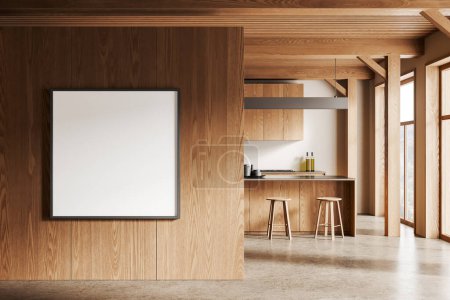 Foto de Interior de cocina moderna con paredes blancas, suelo de hormigón, armarios de madera con cocina incorporada y barra de madera con taburetes. Cuadrado maqueta de póster a la izquierda. renderizado 3d - Imagen libre de derechos