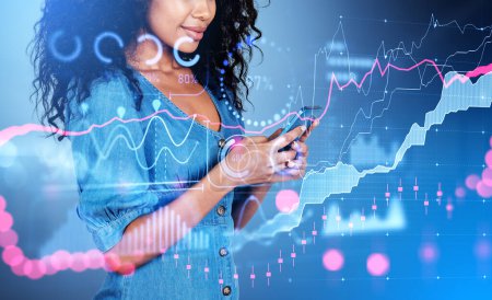 Photo for Black businesswoman working with smartphone, double exposure, colorful forex analysis hud, stock market candlesticks and big business data with security lock. Concept of online trading - Royalty Free Image