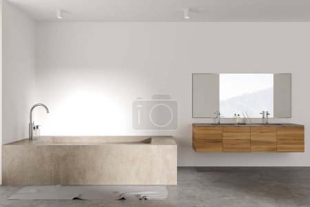 Téléchargez les photos : Intérieur de salle de bain moderne avec murs blancs, sol en béton, baignoire massive et double lavabo en bois avec miroir horizontal suspendu au-dessus. Rendu 3d - en image libre de droit