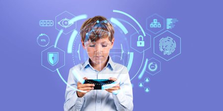 Photo for Portrait of concentrated schoolboy in blue shirt holding smartphone with immersive facial recognition interface standing over purple background. Concept of biometric scanning - Royalty Free Image