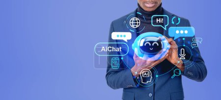 Foto de Hombre de negocios negro con la tableta en las manos, AI chat bot holograma con iconos digitales y burbujas de voz en el espacio de copia de fondo azul. Concepto de aprendizaje automático y asistencia virtual - Imagen libre de derechos