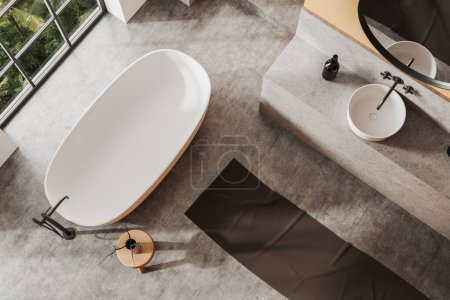 Photo for Top view of modern bathroom with orange walls, concrete floor, comfortable bathtub standing near window and white sink with round mirror. 3d rendering - Royalty Free Image