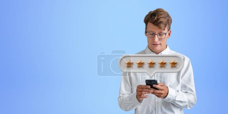 Photo for Satisfied businessman typing in phone in hands, five stars bubble on empty copy space blue background. Concept of giving positive review online, client service and rank - Royalty Free Image