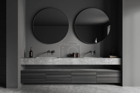 Photo for Dark bathroom interior with double sink and round mirror, black wooden dresser with bath accessories on grey concrete floor. 3D rendering - Royalty Free Image