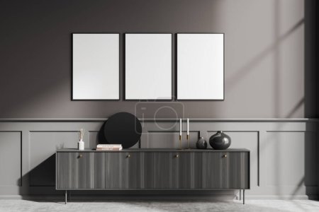 Photo for Dark living room interior with black wooden sideboard and modern decoration on grey concrete floor. Three mock up posters in row. 3D rendering - Royalty Free Image