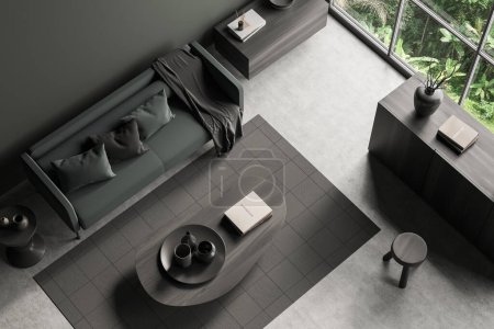 Photo for Top view of dark chill room interior with sofa and dresser with coffee table, carpet on grey concrete floor. Panoramic window on tropics. 3D rendering - Royalty Free Image