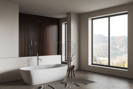 Téléchargez les photos : Élégant intérieur de la salle de bain de l'hôtel avec baignoire et douche derrière la cloison, vue latérale sol en béton gris. Coin baignade confortable avec accessoires et fenêtre panoramique sur la campagne. rendu 3D - en image libre de droit