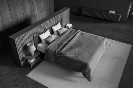 Photo for Top view of stylish bedroom with gray and wooden walls, concrete floor, comfortable king size bed with gray cover standing on carpet and dark gray dresser. 3d rendering - Royalty Free Image
