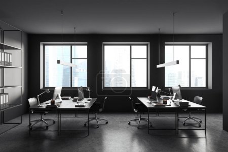 Photo for Dark coworking interior with office chairs and pc computer on a shared table, grey concrete floor. Metallic shelf with folders, business room with panoramic window on skyscrapers. 3D rendering - Royalty Free Image