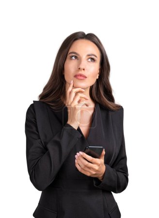 Photo for Businesswoman pensive look with phone in hand. Manager dreaming and making plans, isolated over white background. Concept of network and communication - Royalty Free Image