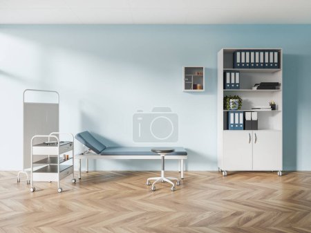 Interior of stylish doctor office with blue walls, wooden floor, comfortable blue examination couch and bookcase with folders standing next to it. 3d rendering