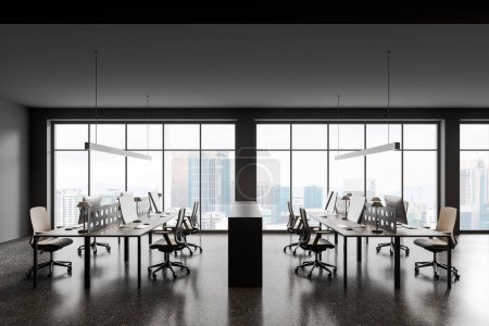 Foto de Moderno interior de coworking con sillas y ordenador PC en el escritorio en fila, piso de hormigón gris. Oficina de negocios y ventana panorámica de los rascacielos Kuala Lumpur. Renderizado 3D - Imagen libre de derechos