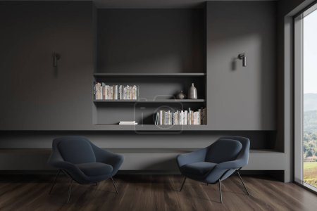 Foto de Interior de elegante sala de estar minimalista con paredes grises, suelo de madera oscura, dos cómodos sillones de color azul oscuro de pie cerca de la ventana y estantes de libros grises. renderizado 3d - Imagen libre de derechos