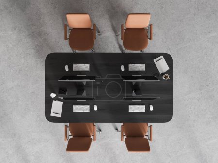 Foto de Vista superior del interior de coworking con monitores de pc en una mesa compartida y cuatro sillones de cuero, piso de hormigón gris. Espacio de trabajo minimalista con herramientas y tecnología. Renderizado 3D - Imagen libre de derechos